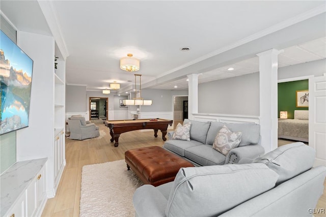 living area with light wood finished floors, a wainscoted wall, pool table, and crown molding