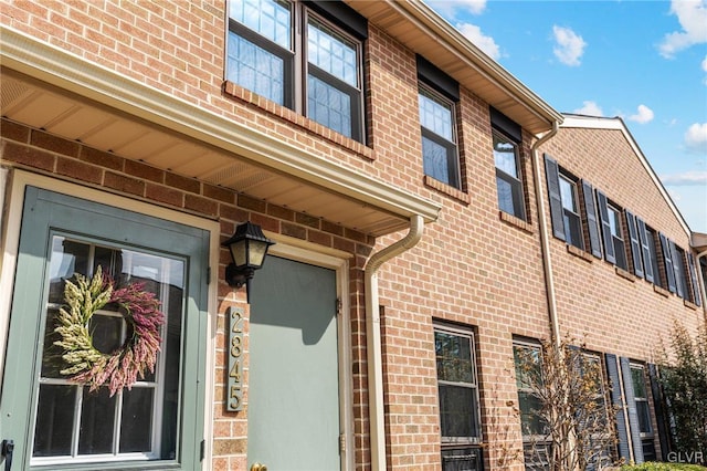 exterior space featuring brick siding