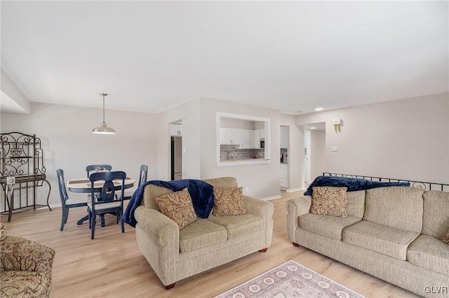 living area with baseboards and light wood-style floors