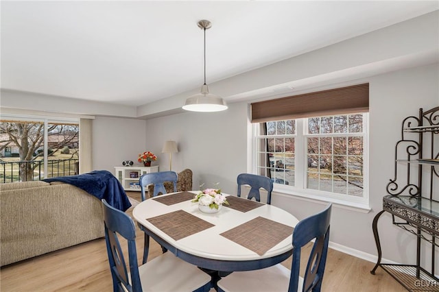 dining room featuring light wood-type flooring and baseboards