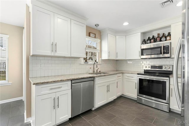 kitchen with visible vents, a healthy amount of sunlight, a sink, appliances with stainless steel finishes, and open shelves