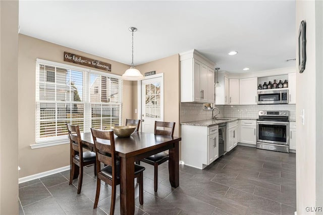 dining area with recessed lighting and baseboards