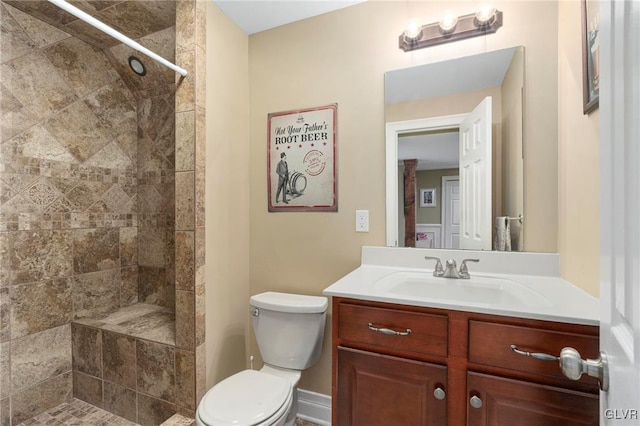 full bathroom featuring vanity, toilet, and tiled shower