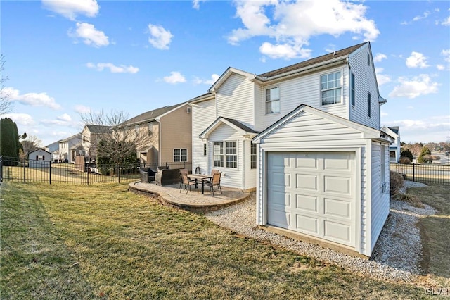 rear view of property featuring a garage, a patio, a lawn, and fence