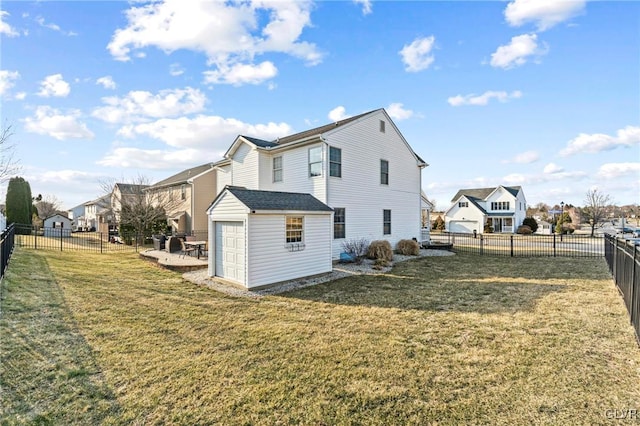 back of property featuring a fenced backyard, a lawn, and a residential view