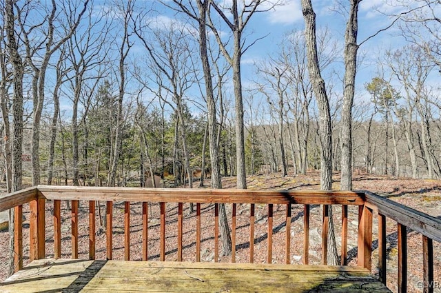 wooden deck with a view of trees