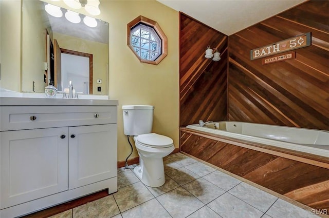 full bath featuring baseboards, toilet, a bath, tile patterned floors, and vanity