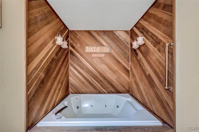 clothes washing area featuring wooden walls