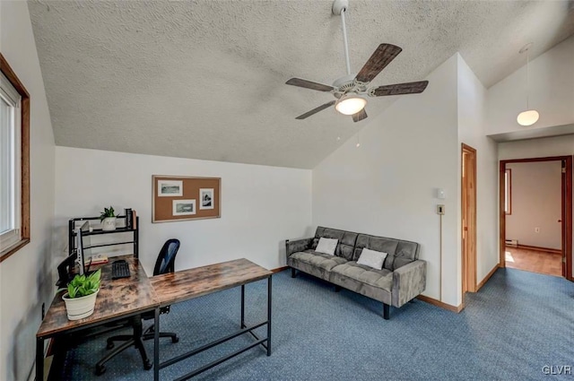 carpeted office featuring baseboards, lofted ceiling, a textured ceiling, and a ceiling fan