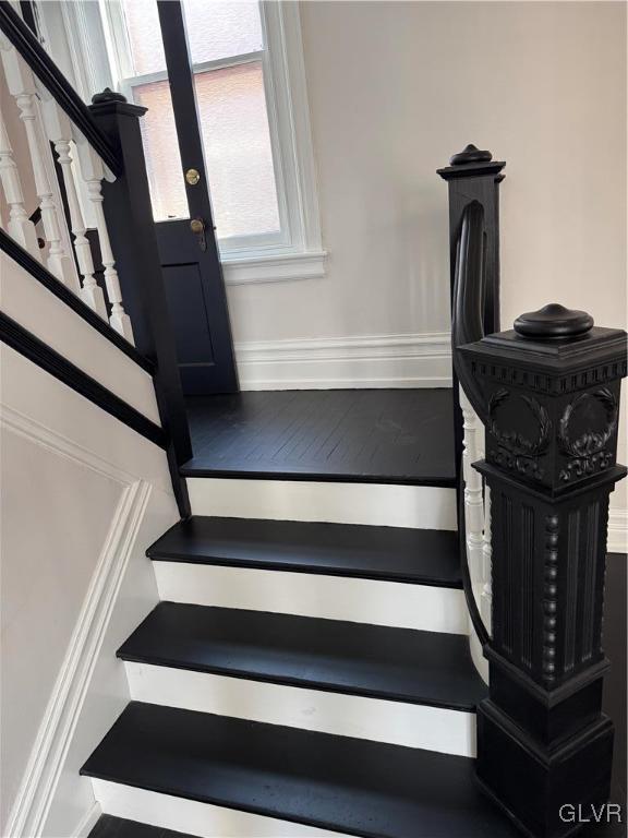 staircase with wood finished floors