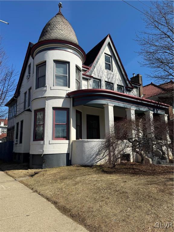 victorian-style house featuring stucco siding