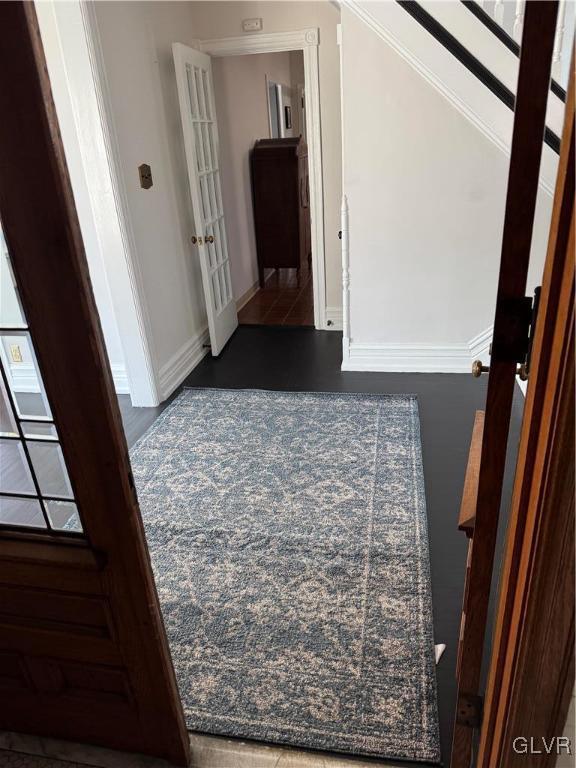 corridor with french doors and baseboards