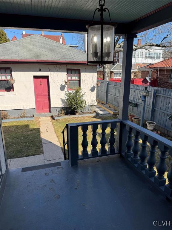 view of patio / terrace featuring a porch and fence