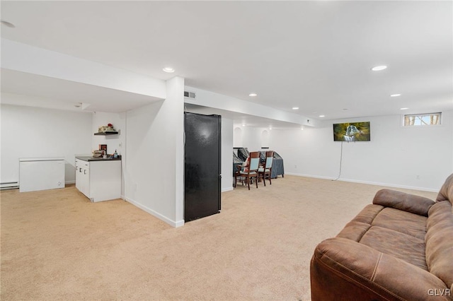 living room featuring visible vents, a baseboard heating unit, baseboards, light colored carpet, and recessed lighting