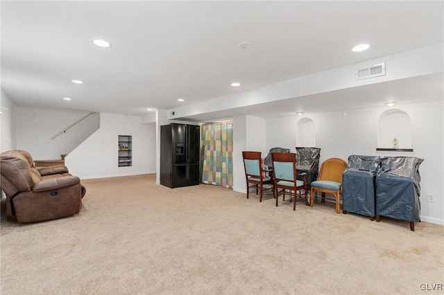 living area with visible vents, recessed lighting, stairway, baseboards, and light colored carpet