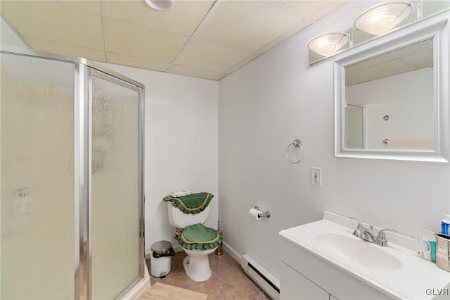 full bathroom with a baseboard heating unit, a paneled ceiling, vanity, and a shower stall