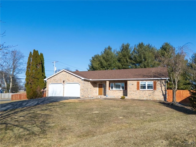 ranch-style home with brick siding, fence, a front yard, a garage, and driveway