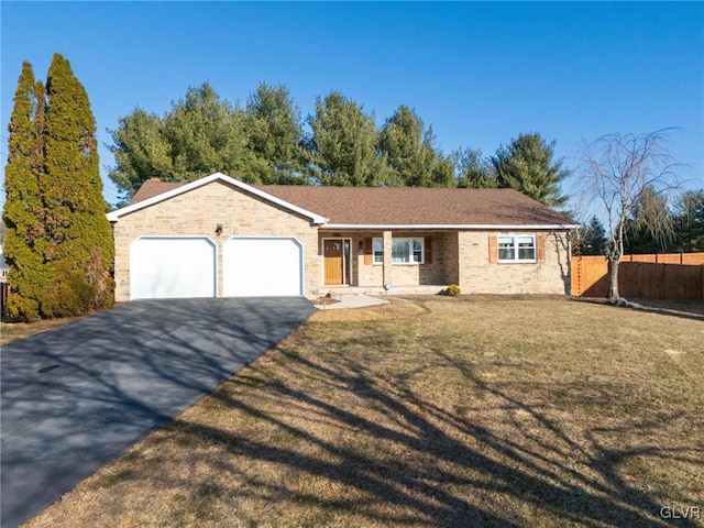 ranch-style home featuring a front yard, fence, driveway, an attached garage, and a chimney