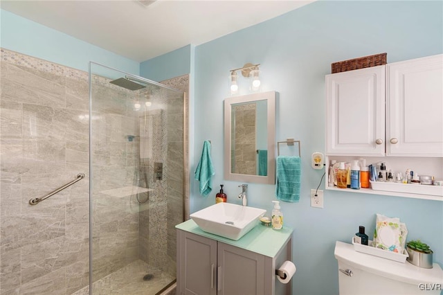 bathroom featuring a walk in shower, toilet, and vanity