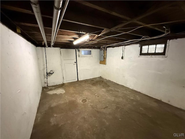 basement with electric panel and plenty of natural light