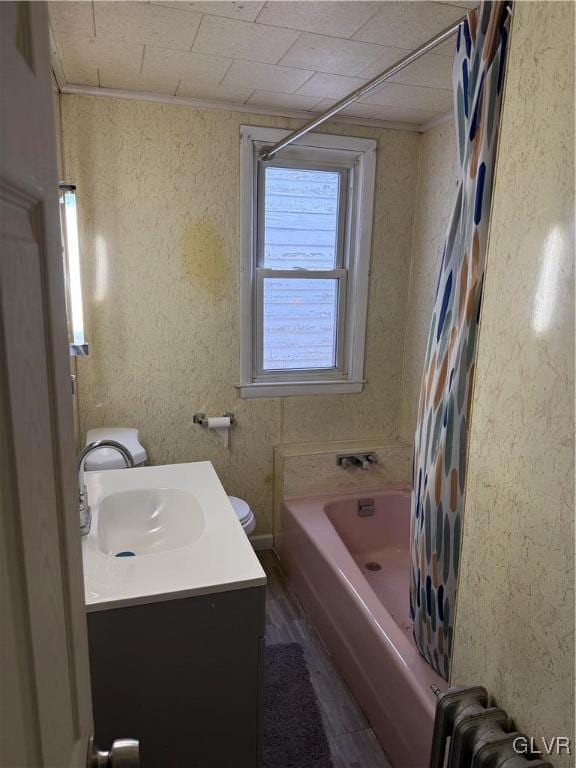 full bathroom with radiator, toilet, ornamental molding, wood finished floors, and vanity