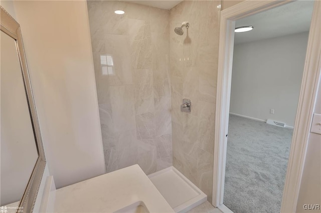 full bathroom with visible vents and a tile shower