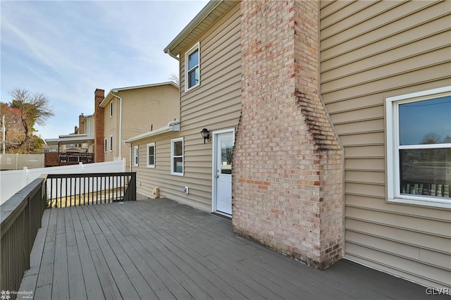 wooden terrace featuring fence