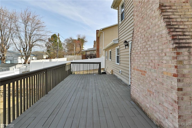 wooden terrace featuring fence