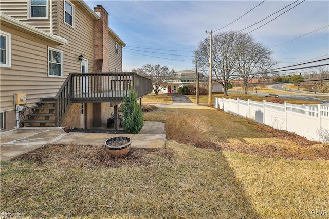 view of yard with stairs, fence, and a wooden deck