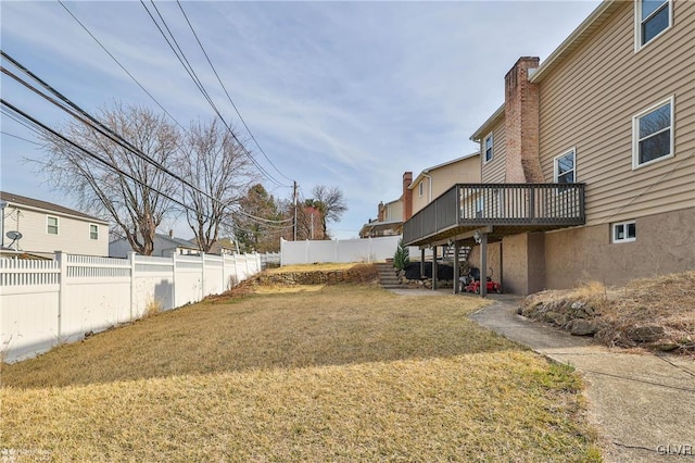 view of yard featuring a fenced backyard and a wooden deck