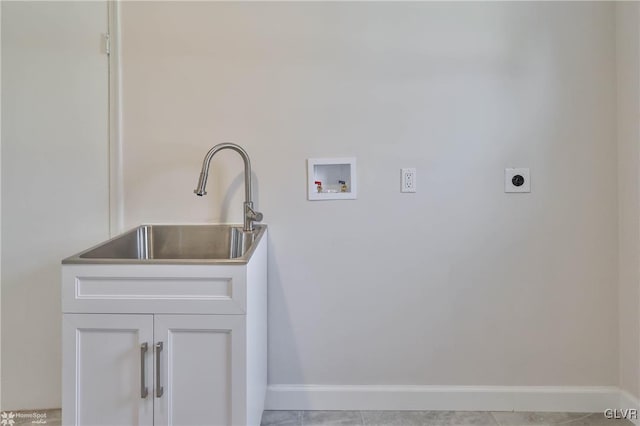 washroom featuring washer hookup, a sink, baseboards, and electric dryer hookup