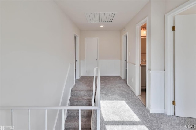 staircase featuring visible vents and carpet