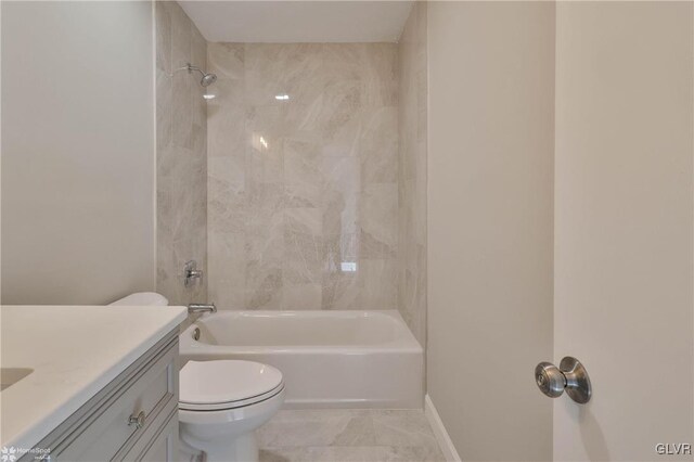 bathroom featuring vanity, toilet, shower / bathtub combination, and baseboards