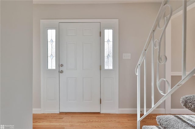 entryway featuring light wood-style flooring and baseboards