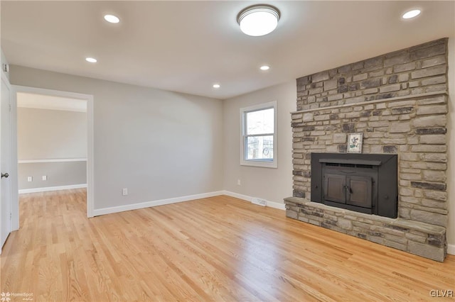 unfurnished living room featuring recessed lighting, baseboards, and wood finished floors