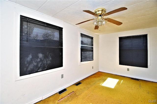 spare room featuring visible vents, baseboards, and ceiling fan