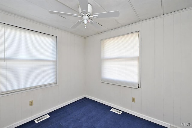 spare room with visible vents, baseboards, and ceiling fan