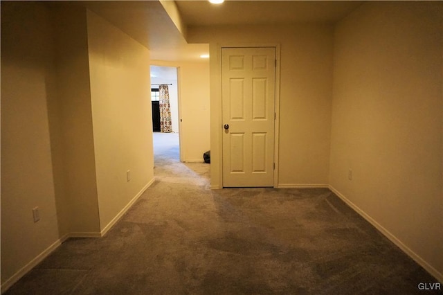 corridor with baseboards and carpet floors