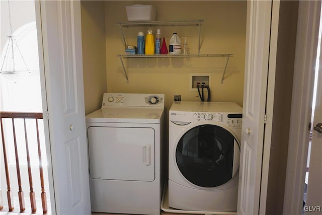 washroom featuring laundry area, washer and dryer, and a healthy amount of sunlight