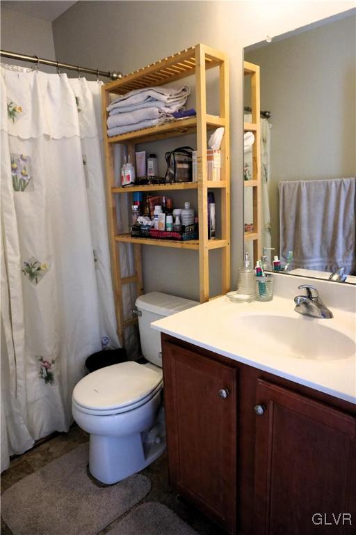 full bathroom featuring toilet and vanity