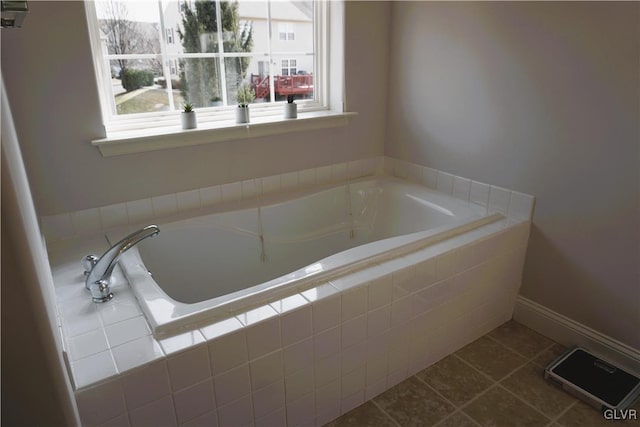 full bath with tile patterned floors, baseboards, and a garden tub