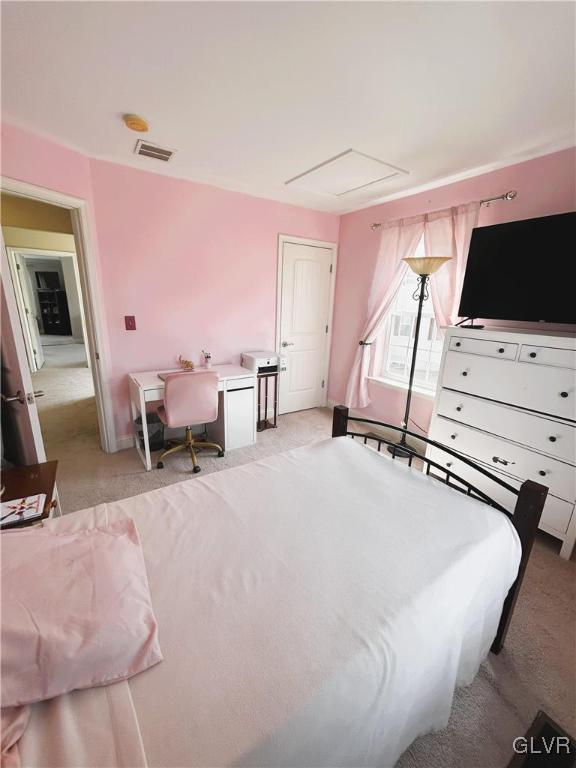 bedroom featuring light carpet and visible vents