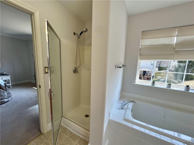 bathroom featuring a garden tub and a stall shower