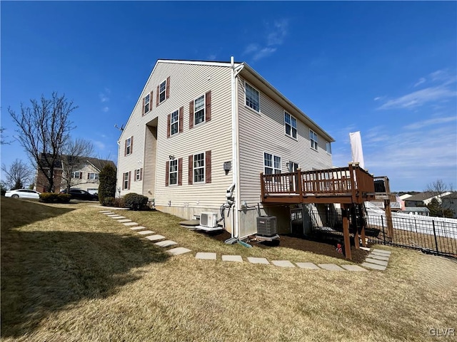 back of house with fence, a wooden deck, central AC, ac unit, and a lawn