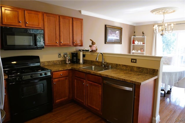 kitchen with a peninsula, dark wood-style flooring, a sink, black appliances, and dark countertops