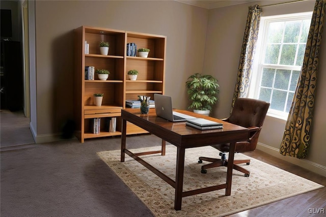 carpeted home office featuring baseboards