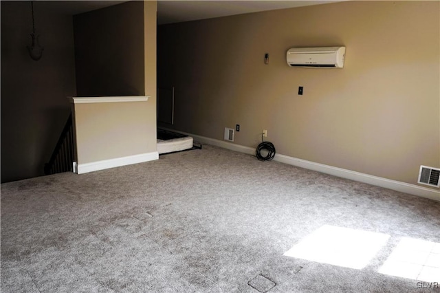 carpeted empty room featuring visible vents, baseboards, and an AC wall unit