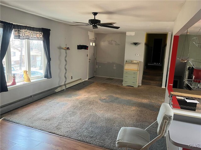 interior space featuring a ceiling fan and baseboard heating