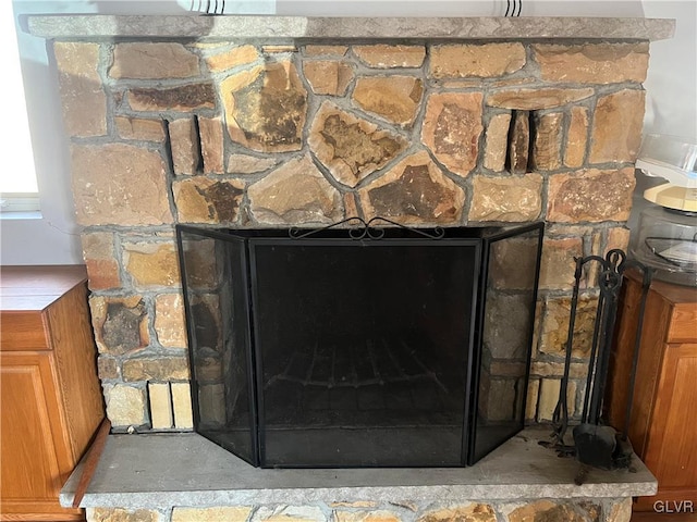 details with a fireplace with raised hearth