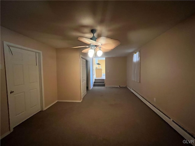 carpeted empty room featuring baseboards, ceiling fan, and a baseboard radiator